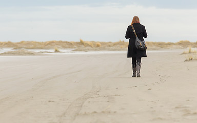 Image showing Lonely woman walking on a beach