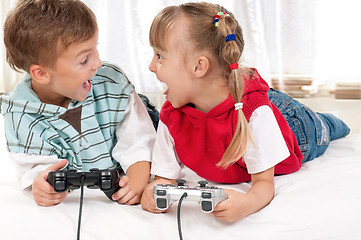 Image showing Happy girl and boy playing a video game