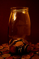 Image showing Coins in a glass bottle