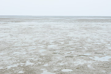 Image showing Cracked earth on the sea background. 