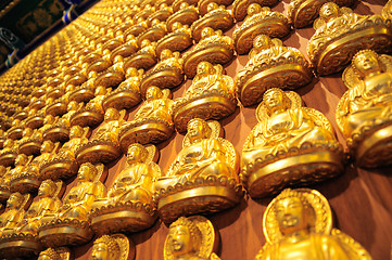 Image showing Many small Buddha statue on the wall at chinese temple, Thailand 