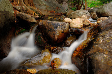 Image showing Waterfall with water flowing around 