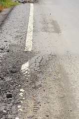 Image showing closeup of cracks on asphalt road 