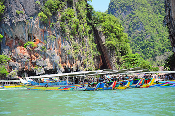 Image showing Long-tail boats on rock background. Thailand. 