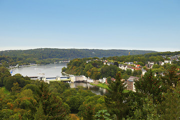 Image showing Settlement along a beautiful lush river