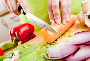 Image showing Woman's hands cutting vegetables