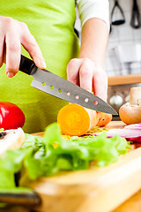 Image showing Woman's hands cutting vegetables