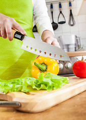 Image showing Woman's hands cutting vegetables