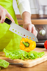 Image showing Woman's hands cutting vegetables