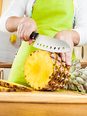 Image showing Woman's hands cutting pineapple