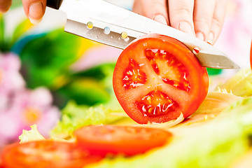 Image showing Woman's hands cutting tomato