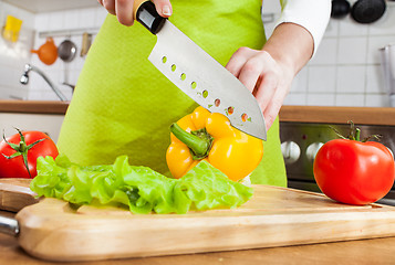 Image showing Woman's hands cutting vegetables