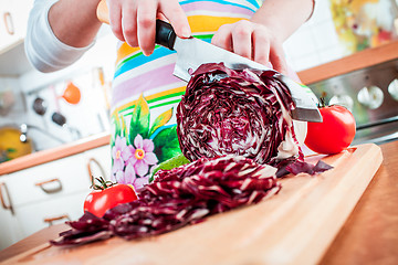 Image showing Woman's hands cutting red cabbage