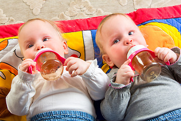 Image showing babies eating from bottle