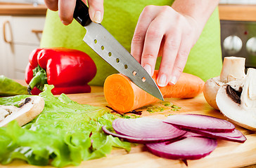 Image showing Woman's hands cutting vegetables