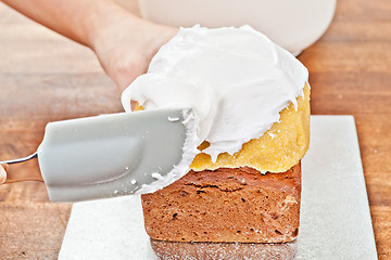 Image showing Spreading cream with spatula