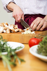 Image showing Man Cutting Mushrooms On Chopping Board