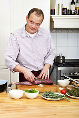 Image showing Man Preparing Meat At Kitchen Counter