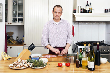 Image showing Man Preparing Meat At Kitchen Counter