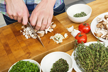 Image showing Closeup Of Man Chopping Mushrooms