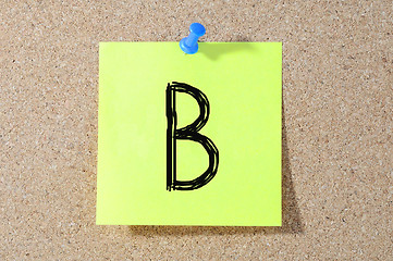 Image showing B grade written on a test paper. 