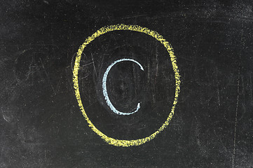 Image showing copyright symbol sketched with white chalk on blackboard 