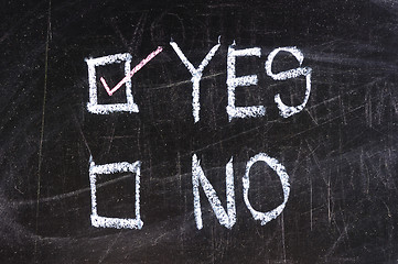 Image showing yes and no check boxes sketched with white chalk on blackboard with eraser smudges 