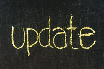 Image showing The word UPDATE handwritten with chalk  on a blackboard