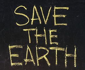 Image showing save the world written on blackboard 