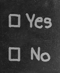 Image showing yes and no check boxes sketched with white chalk on blackboard with eraser smudges 