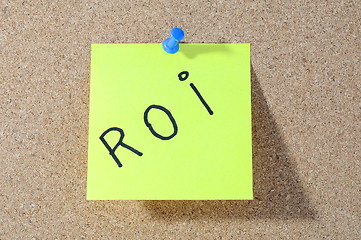 Image showing The word ROI Note paper with push pins on noticeboard 