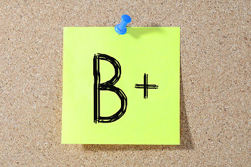 Image showing B+ grade written on a test paper. 