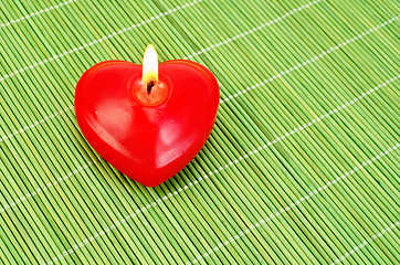 Image showing Heart of candles on a green bamboo