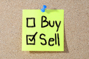 Image showing Buy or sell check boxes written on a board 