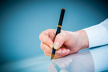 Image showing Woman's hand and pen