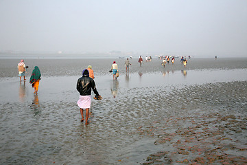 Image showing During low tide the water in the river Malta falls so low that people walk to the other shore in Canning Town