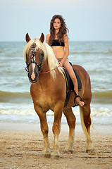 Image showing teen girl riding a horse