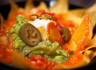 Image showing Nachos with salsa verde and olives