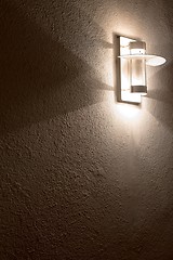 Image showing Modern lamp on concrete wall