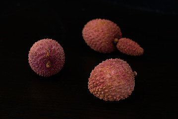 Image showing Exotic lychee fruit on dark background