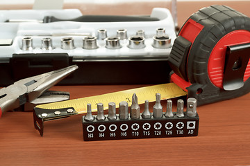 Image showing screwdriver toolbox with set of bits, pliers and measuring tape