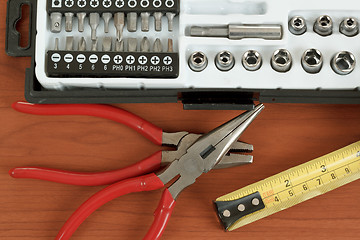 Image showing screwdriver toolbox with set of bits, pliers and measuring tape