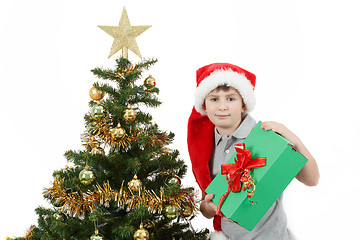 Image showing happy boy in santa hat show christmas present