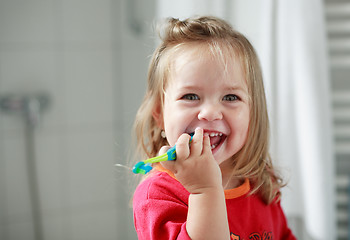 Image showing Small girl washing her teeth