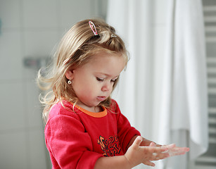 Image showing Small girl washing her hands