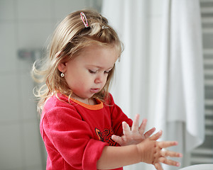 Image showing Small girl washing her hands