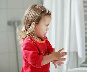 Image showing Small girl washing her hands