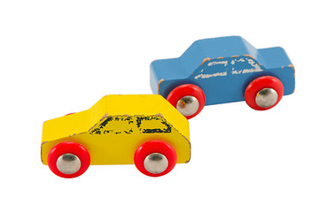 Image showing pair wooden blue yellow retro toy cars isolated 