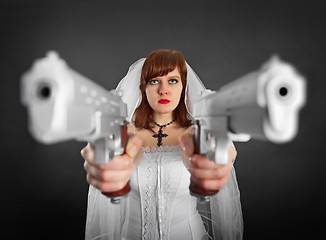 Image showing Beautiful bride armed with two pistols