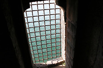 Image showing Grilled castle window overlooking the sea